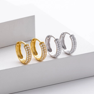 Macro detail of gold and silver S925 sterling silver hoop earrings with pavé zircons