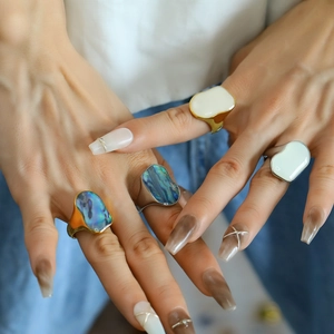 Irregular chunky 18K gold and silver rings with iridescent abalone shell inlays