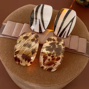Square acrylic stud earrings with retro leopard and zebra patterns on silk