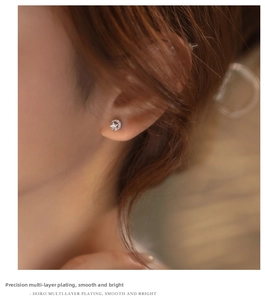Close-up of sparkling star and moon stud earrings featuring high-quality plating and stones