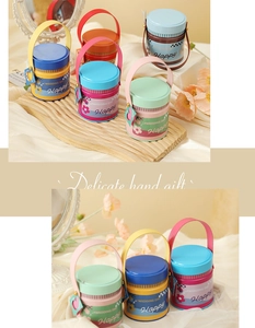 Detail of mini cylindrical tinplate gift boxes with heart tags for wedding favors