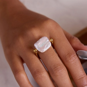 Elegant gold titanium steel ring with a large rectangular baroque freshwater pearl