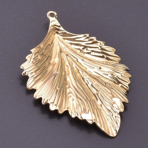 Macro detail of 18k gold plated stainless steel leaf pendant with realistic vein texture