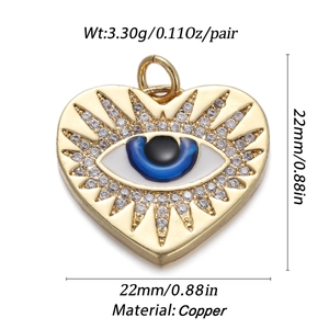 Detailed view of a gold-plated copper heart-shaped evil eye pendant with tiny crystals