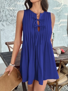 Detail of blue sleeveless pleated mini dress with elegant front lace-up tie design