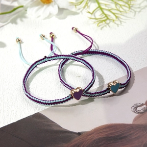 Adjustable woven couple bracelets with heart pendants in purple and teal blue tones