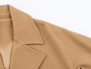 Detailed close-up of camel wool coat collar and shoulder with refined texture