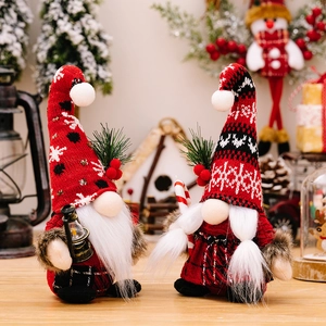 Christmas Gnomes set with knitted hats, lantern and candy cane on a festive background