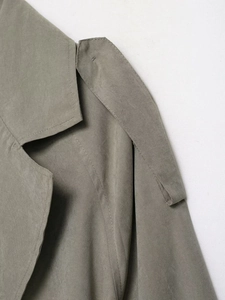 Detailed macro view of the sage green suede collar and shoulder epaulettes on a casual jacket