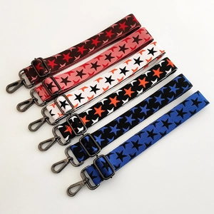 Adjustable wide woven guitar straps with star patterns and dark metal lobster clasps