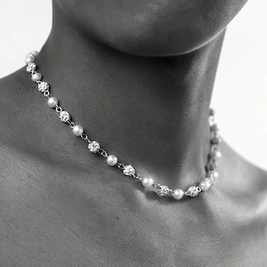 Retro hip-hop cross necklace with imitation pearls and rhinestones on a male model