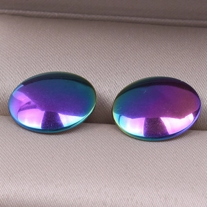Macro shot of oval gradient rainbow stainless steel earrings with metallic finish