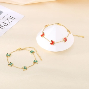Elegant gold titanium butterfly bracelets in red enamel and malachite green stones