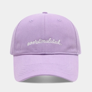 Close-up of white overstimulated embroidery on premium purple cotton baseball cap