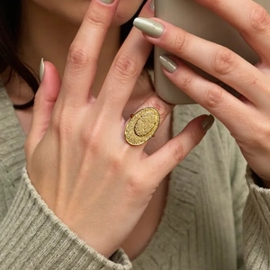 Minimalist 18K gold plated ring with hammered texture worn on finger in mirror selfie