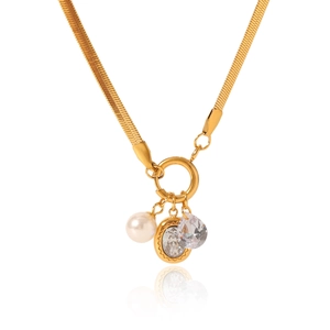 Detail of gold snake chain necklace featuring pearl, round and teardrop zircon charms