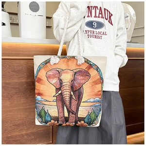 Close-up of elephant embroidery pattern on canvas tote bag with thick rope straps