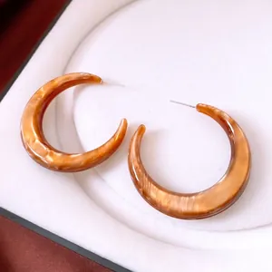 Vintage amber resin C-shaped hoop earrings with a sophisticated marble texture finish