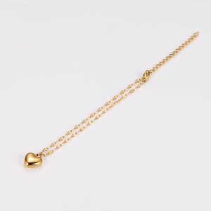 Polished gold heart pendant bracelet with a minimalist fine chain and glossy finish