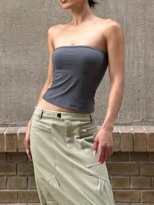 Elastic strapless tube top in dark grey styled with green cargo skirt on street background
