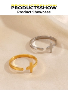 Detailed view of polished cross open rings in gold and silver on satin fabric