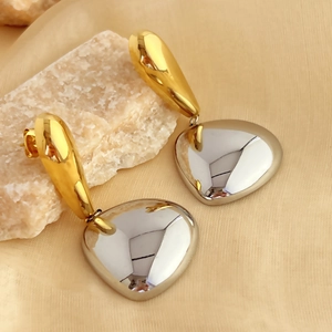 18K gold plated stainless steel teardrop and silver heart earrings on silk background