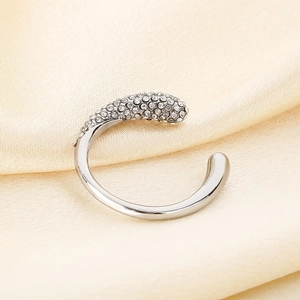 Detailed macro view of an adjustable silver C-shaped ear cuff with sparkling rhinestones