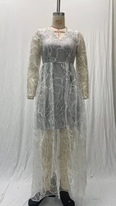 Detail of elegant white floral lace embroidery on long sleeve mesh evening gown