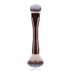 Detail view of dual-ended makeup brush with rose gold handle and gradient synthetic bristles