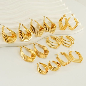 Vue détaillée de boucles d'oreilles dorées géométriques superposées de formes variées