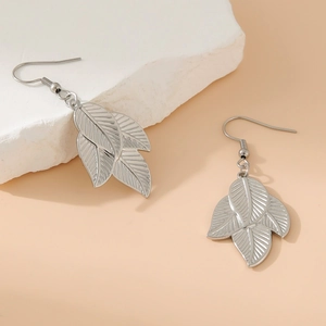 Minimalist silver leaf pendant earrings made of stainless steel on natural stones