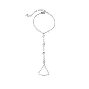 Detail of silver hand chain with clear crystals on white background featuring lobster clasp