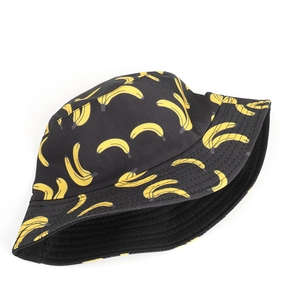 Close-up of yellow banana print on durable black canvas fabric of a reversible bucket hat