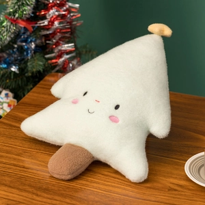 Detailed view of a soft plush Christmas tree pillow with a smiling face on a wooden table