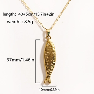 Gold tropical fish pendant necklace in titanium steel with detailed scales on white background