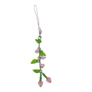 Handmade beaded cherry phone strap with pink glass beads and metal chain on white background