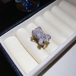 Sparkling zircon bow open ring in silver finish displayed in a white jewelry box