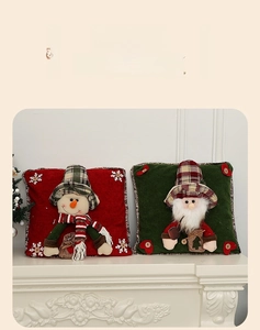 Detail of Christmas pillow covers featuring 3D Santa and snowman appliques on a mantel