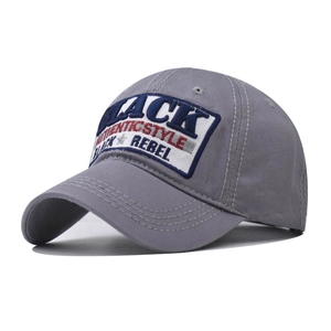 Detail of grey cotton baseball cap with multi-colored embroidered patches and reinforced stitching