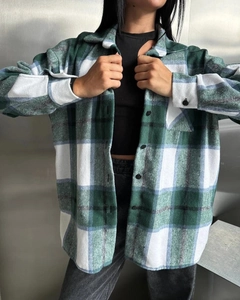 Close-up of green and blue plaid wool shirt with button collar and soft fabric texture