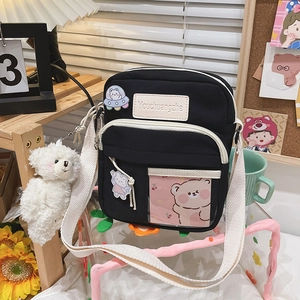 Détails du sac bandoulière en toile noire avec poche transparente et badges mignons