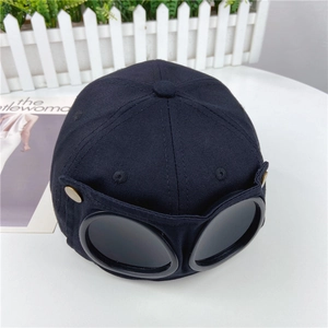 Detail view of cotton twill baseball cap featuring integrated goggles and gold buttons