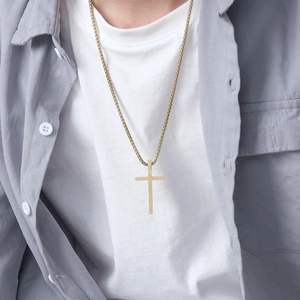 Minimalist matte gold cross pendant necklace on a stainless steel chain for men and women