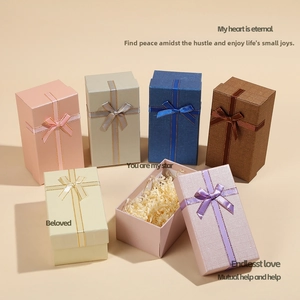 Detailed view of colorful rectangular jewelry gift boxes with satin ribbon bow knots