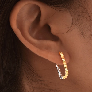 Women's gold and silver stainless steel hoop earrings with textured diamond-cut pattern