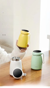 Close-up of smart mushroom vacuum flasks with LED temperature display and silicone strap