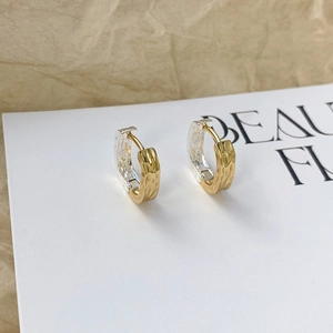 Luxury S925 sterling silver hoop earrings featuring artistic lava texture and two-tone finish