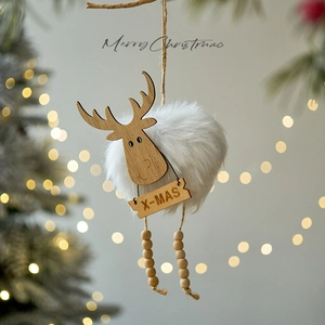 Handmade wooden reindeer Christmas ornament with plush fur and beads on a festive tree branch
