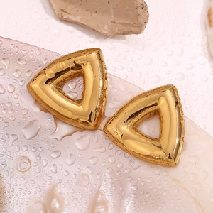 Macro view of 18K gold plated stainless steel hollow triangle earrings on a wet stone