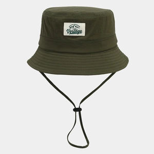 Detail of dark green quick-dry bucket hat with mountain patch and windproof rope